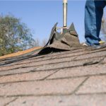 Worker Removing Old Shingle Roof for Replacement